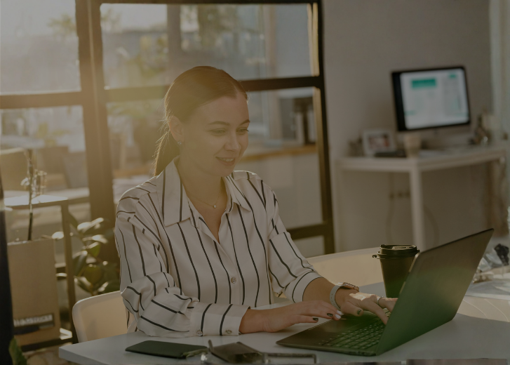 woman working on laptop smiling 